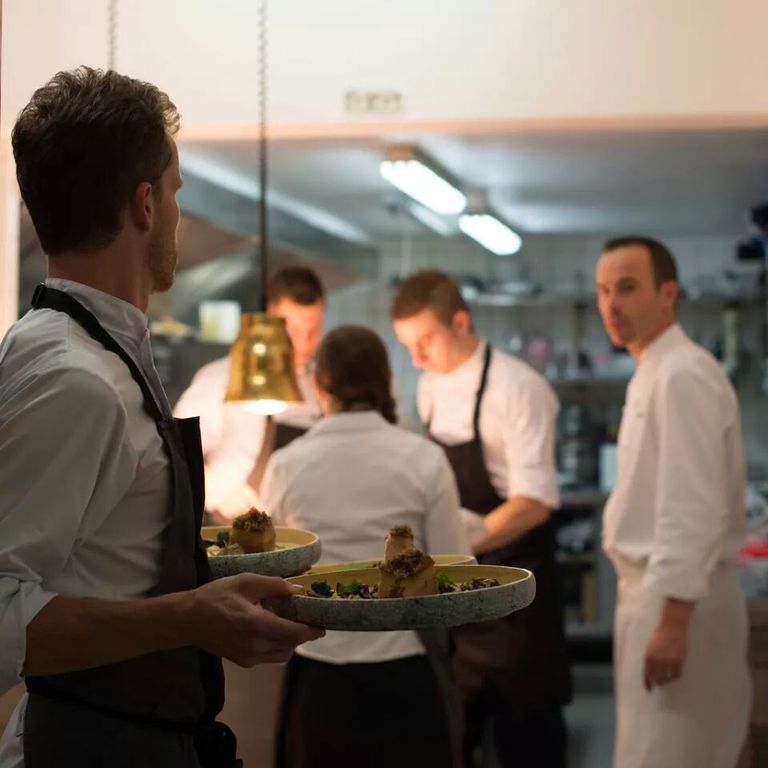 A team of 5 people, including Chef Christophe Hay, in the kitchen.