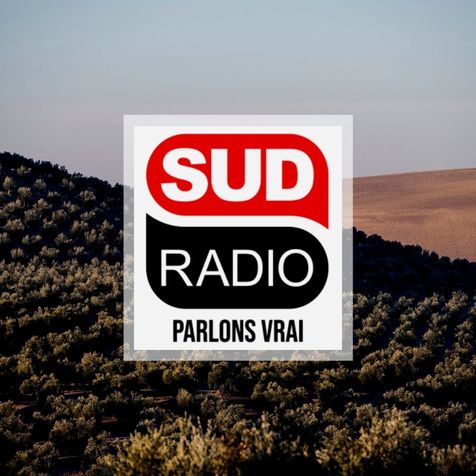 Logo Sud Radio rouge et noir avec comme arrière plan une oliveraie vue du ciel en andalousie, Espagne.