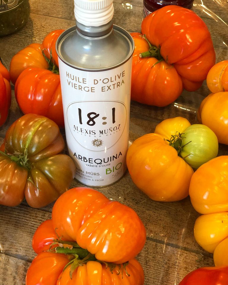 Heirloom tomatoes, vibrant and colorful, drizzled with a can of olive oil, 18:1.
