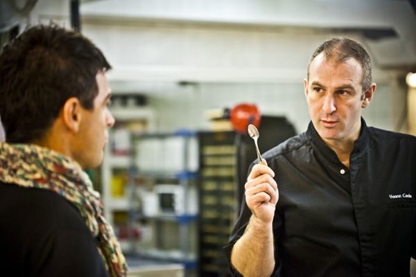 Olive oil producer and oleologist Alexis Muñoz tasting and discussing with Chef Yoann Conte in the kitchen of his restaurant.