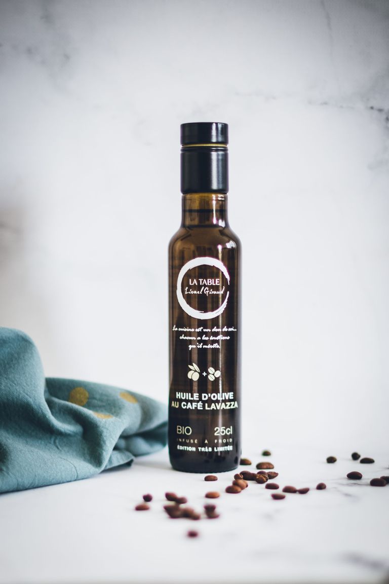 A bottle of coffee-infused olive oil. The bottle is made of opaque glass.