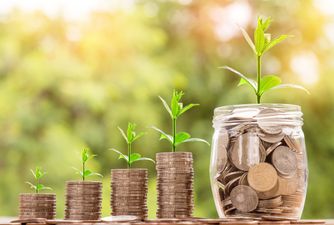 Pile of coins bringing young seedlings to life.